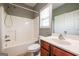 Bright bathroom with a shower-tub combo, vanity, and window for natural light at 4311 Hampton Mill Pkwy, Douglasville, GA 30135