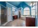 Blue bathroom with a large bathtub, shower, vanity, and plenty of natural light at 4311 Hampton Mill Pkwy, Douglasville, GA 30135