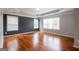 Bedroom featuring large windows, hardwood floors, and gray accent wall at 4311 Hampton Mill Pkwy, Douglasville, GA 30135