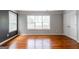 Bedroom with hardwood floors, a large window, closet, and gray accent wall at 4311 Hampton Mill Pkwy, Douglasville, GA 30135