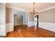 Spacious dining room featuring hardwood floors, classic wainscoting, and a stylish chandelier at 4311 Hampton Mill Pkwy, Douglasville, GA 30135