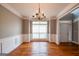 Dining area showcasing wainscoting, hardwood floors, a chandelier, and a large window at 4311 Hampton Mill Pkwy, Douglasville, GA 30135