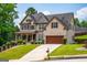 Attractive two-story home featuring a brick facade, attached garage, and a lush green lawn at 4311 Hampton Mill Pkwy, Douglasville, GA 30135