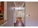 Hallway with hardwood floors and a view of the front door, kitchen, and entry to other rooms at 4311 Hampton Mill Pkwy, Douglasville, GA 30135