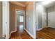 Hallway with hardwood floors, and ample lighting creating a bright and inviting space at 4311 Hampton Mill Pkwy, Douglasville, GA 30135