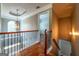 Open hallway featuring hardwood floors, ornate railing and trim, plus attractive window and lighting at 4311 Hampton Mill Pkwy, Douglasville, GA 30135
