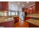 Gourmet kitchen featuring granite countertops, stainless steel appliances, and a breakfast bar opening to the living area at 4311 Hampton Mill Pkwy, Douglasville, GA 30135