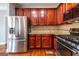 Gourmet kitchen featuring granite countertops, stainless steel appliances, and a breakfast bar opening to the living area at 4311 Hampton Mill Pkwy, Douglasville, GA 30135