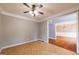 Open living area featuring tiled floors, ceiling fan, and connection to dining room with hardwood floors at 4311 Hampton Mill Pkwy, Douglasville, GA 30135