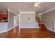 Inviting living room showcasing hardwood floors, complemented by a staircase, and a seamless transition to the kitchen at 4311 Hampton Mill Pkwy, Douglasville, GA 30135