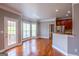 Bright living room with a door to a deck and views into kitchen with granite countertops and stainless steel appliances at 4311 Hampton Mill Pkwy, Douglasville, GA 30135