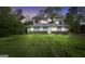 Charming single-story home featuring a brick foundation, light blue siding, and well-maintained lawn at dusk at 758 King Rd, Jonesboro, GA 30236