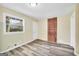 Bright room featuring hardwood floors, a brick feature wall, and a large window at 758 King Rd, Jonesboro, GA 30236