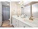 Bright bathroom with double vanity sinks with bronze fixtures and framed mirror above, and shower access at 204 Carmell Ct, Mcdonough, GA 30252