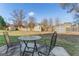 Spacious backyard with a table and chairs, surrounded by a wooden fence at 453 Camp Hill Ln, Jonesboro, GA 30238