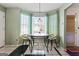 Bright breakfast nook with a round table, two chairs, a large window, and tile floor at 453 Camp Hill Ln, Jonesboro, GA 30238