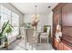 Bright dining room with a round glass table, upholstered chairs, and abundant natural light at 453 Camp Hill Ln, Jonesboro, GA 30238