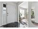 Bright foyer with marble floors leading to a dining room with natural light and neutral colored walls at 453 Camp Hill Ln, Jonesboro, GA 30238