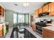 Traditional kitchen with black and white tile floor, updated appliances, and eat-in dining area at 453 Camp Hill Ln, Jonesboro, GA 30238