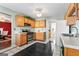 Traditional style kitchen with oak cabinets and black appliances at 453 Camp Hill Ln, Jonesboro, GA 30238