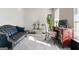 Cozy living room featuring a sofa, desk, modern decor, and soft natural light, perfect for relaxation at 453 Camp Hill Ln, Jonesboro, GA 30238