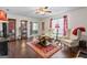 Spacious living room with hardwood floors, large windows, stylish furniture, and modern decor at 453 Camp Hill Ln, Jonesboro, GA 30238