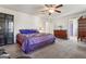 Spacious main bedroom featuring plush carpet, a ceiling fan, and an ensuite bathroom at 453 Camp Hill Ln, Jonesboro, GA 30238