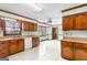 Traditional kitchen with wood cabinets, white appliances, and an adjacent dining area at 210 Heritage Cir, Mcdonough, GA 30253