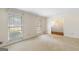 Bright living room showcasing two windows and an open doorway at 210 Heritage Cir, Mcdonough, GA 30253
