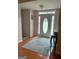 Foyer featuring hardwood floors, a decorative rug, and natural light at 1129 River Green Ct, Mcdonough, GA 30252