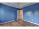 Cozy bedroom with wood floors, a closet, and plenty of natural light with calming blue-painted walls at 1067 Misty Meadows Pt, Hampton, GA 30228