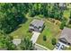 Aerial view of a home with a well-manicured lawn and mature trees at 470 Louise Way, Locust Grove, GA 30248