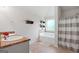 Bathroom featuring double vanity sinks, tiled floors, and separate tub at 470 Louise Way, Locust Grove, GA 30248