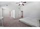 Bright primary bedroom with carpet, ceiling fan, and natural light at 470 Louise Way, Locust Grove, GA 30248