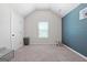 Bright bedroom featuring a painted accent wall, neutral carpet, and plenty of natural light at 470 Louise Way, Locust Grove, GA 30248