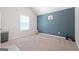 Bedroom featuring a painted accent wall, neutral carpet, and plenty of natural light at 470 Louise Way, Locust Grove, GA 30248