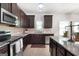Traditional kitchen featuring dark cabinets, stainless steel appliances, and granite countertops at 470 Louise Way, Locust Grove, GA 30248