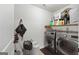 A laundry room featuring a front load washer and dryer, shelving, and tile floors at 470 Louise Way, Locust Grove, GA 30248