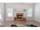 Living area highlighting brick fireplace, shiplap accent wall, and natural light from windows at 470 Louise Way, Locust Grove, GA 30248