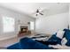 Cozy living room with a fireplace, ceiling fan, and comfortable seating at 470 Louise Way, Locust Grove, GA 30248