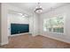 Light and airy living space with wood-look floors, large windows and a modern lighting fixture at 470 Louise Way, Locust Grove, GA 30248