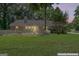 Backyard view featuring a large chimney and white picket fence at 380 Peach Drive, Mcdonough, GA 30253