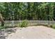 Backyard has a white picket fence and a garden to enjoy the outdoors at 380 Peach Drive, Mcdonough, GA 30253