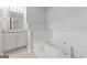 The bathroom has a separate sink and an oversized tub with tiled accents at 380 Peach Drive, Mcdonough, GA 30253