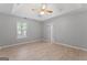A bright bedroom includes a ceiling fan and window. The doorway leads to another room at 380 Peach Drive, Mcdonough, GA 30253
