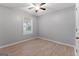 Comfortable bedroom featuring light-filled window and tile floors at 380 Peach Drive, Mcdonough, GA 30253