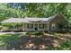 Charming single-story home featuring a stone facade, inviting front porch and nicely landscaped front yard at 380 Peach Drive, Mcdonough, GA 30253