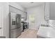 Modern kitchen featuring stainless steel appliances and gray cabinets at 380 Peach Drive, Mcdonough, GA 30253