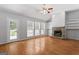 Bright living room features a stone fireplace, hardwood floors, and large windows at 380 Peach Drive, Mcdonough, GA 30253