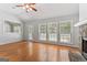 Living room featuring hardwood floors, a stone fireplace, and lots of natural light at 380 Peach Drive, Mcdonough, GA 30253